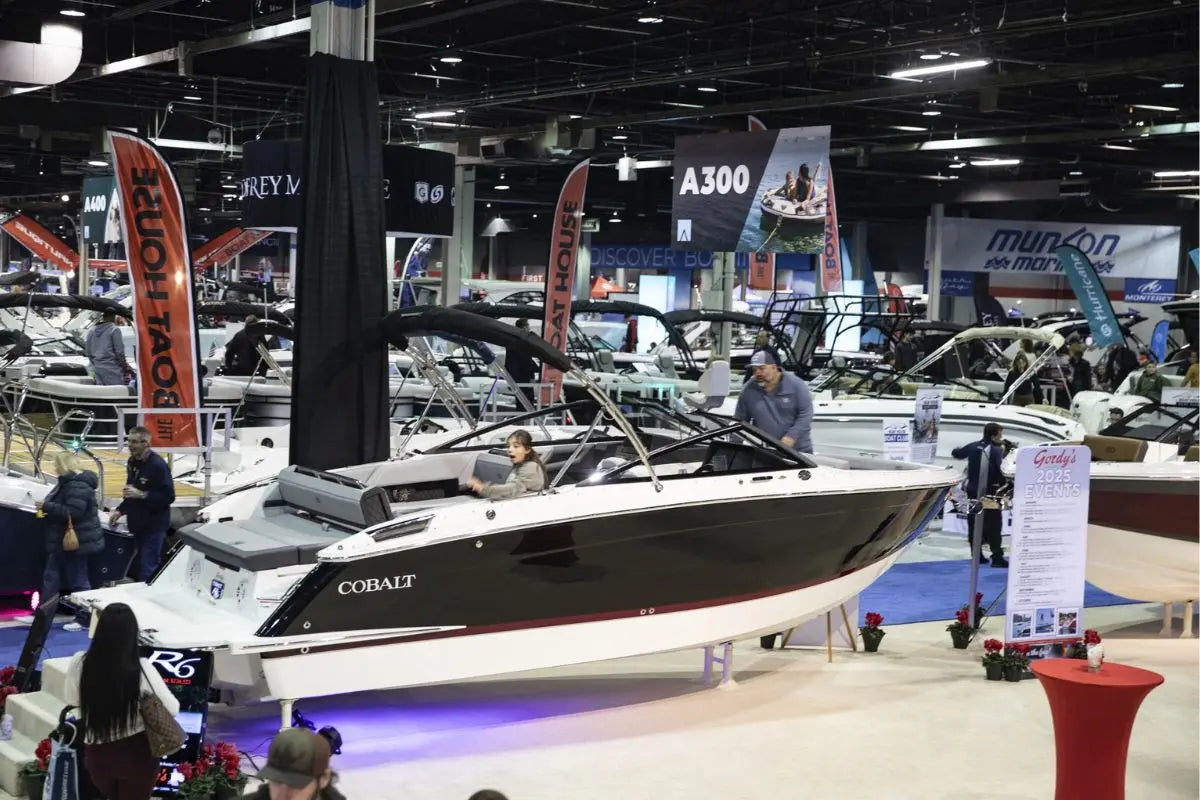 Show floor at the 2026 Chicago Boat Show in Rosemont featuring rows of powerboats and exhibitor banners. Visit Booth A600 to see Rover Marine and POP Board Co