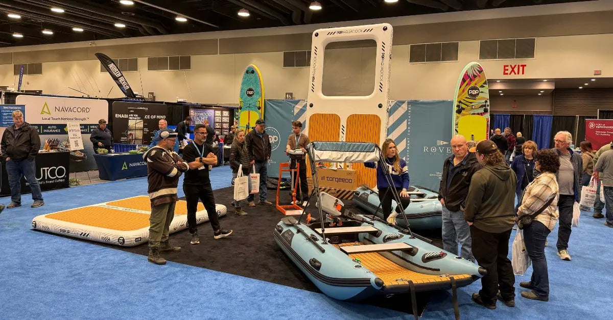 PopBoard Co inflatable dock and Rover Marine inflatable boats showcased at an indoor marine trade show with attendees viewing the display