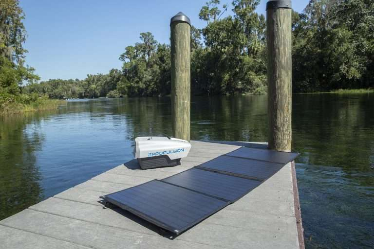 Epropulsion electric outboard battery charging with portable solar panels on a dock.